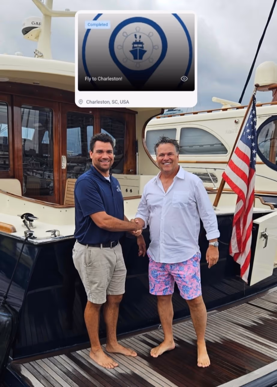 Two marine professionals shaking hands on a dock after meeting on Harbor
